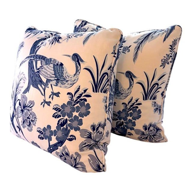 A beautifully tailored pair of chinoiserie-style accent pillows featuring an elegant bird and floral motif in layered blue...