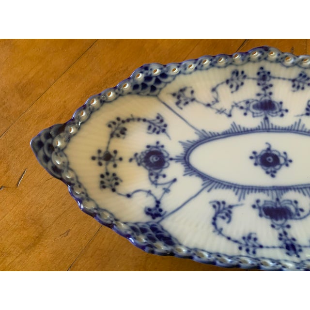 Hand painted cobalt blue motifs used as a pickle dish, spoon tray, or small serving platter.