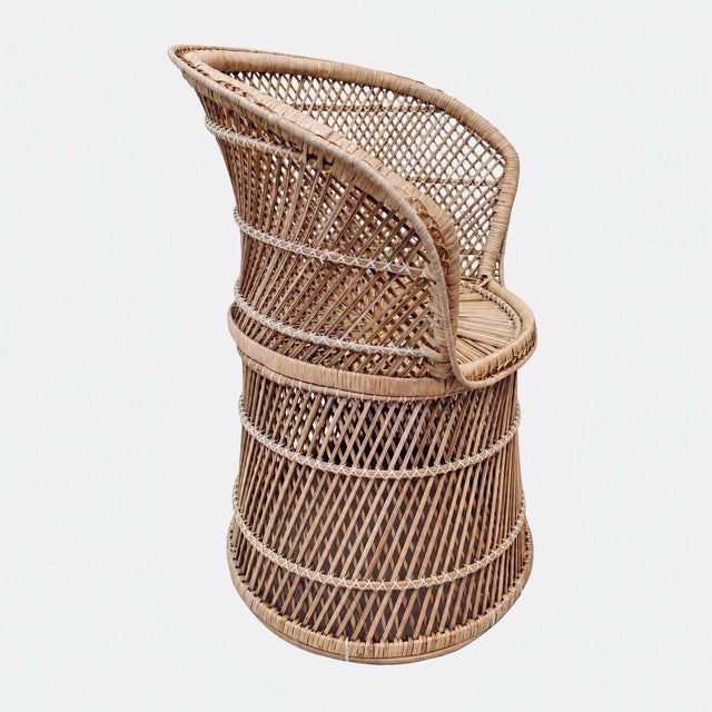 Sculptural 1970s bohemian rattan peacock-style barrel chair featuring a distinctive flared hoop back, intricate diamond...