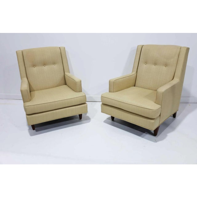 The “Mr.” chair from one of Edward Wormley designs for Dunbar. The pair is upholstered in a woven fabric. Chair has a high...