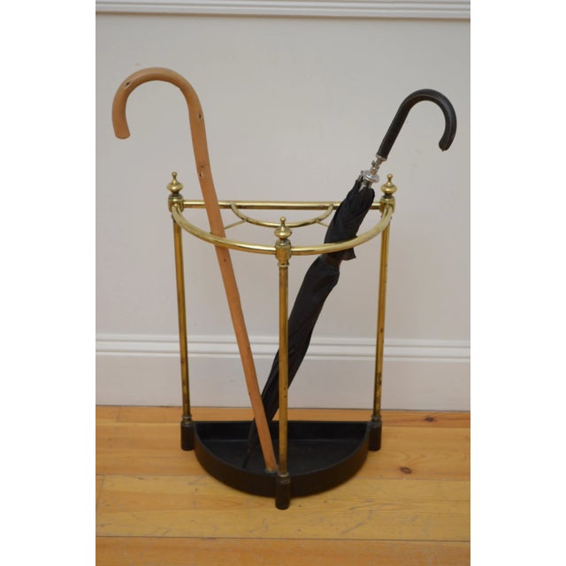 English Victorian brass umbrella stand or walking stick stand with five divisions, three decorative finials and cast iron...