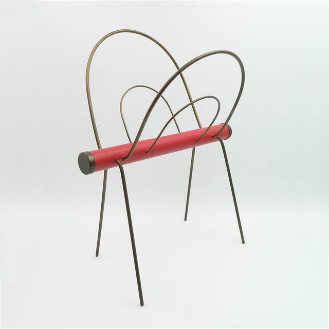 Newspaper stand made of brass with red leather from the 60s produced in the style of the Auböck Vienna workshop. This...