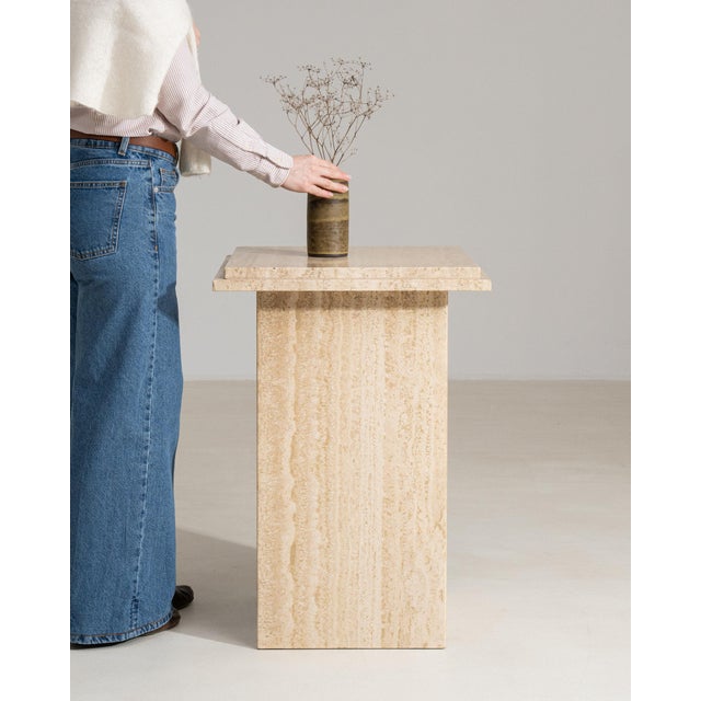 This piece presents as a piece, distinguished by cream travertine stone, blocky form. Dating to 1970s and originating from...