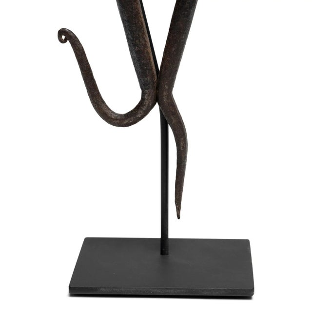 This hand-forged metal sculpture, with its delicate appearance and whimsical shape, was once an integral tool to a 19th...