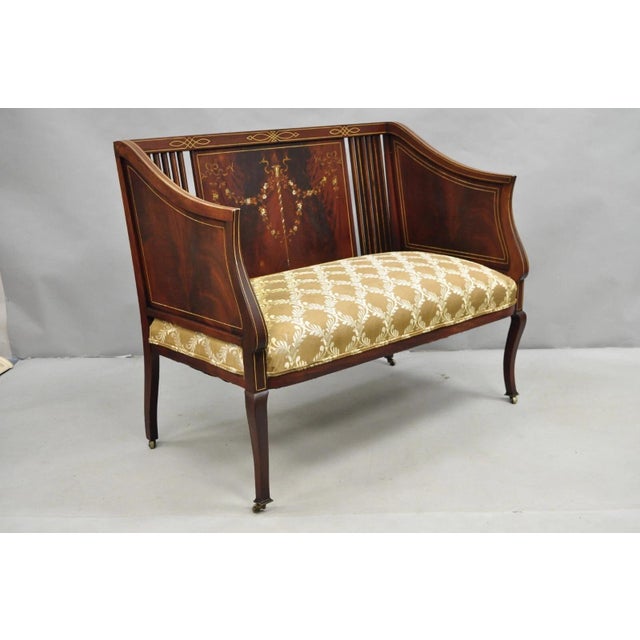 Antique Victorian Edwardian Mahogany Settee Loveseat Sofa with Mother of Pearl Inlay and Rolling Casters. Circa Late 19th...