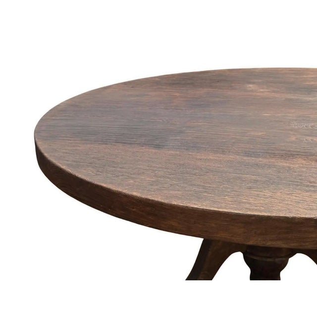 Crafted from solid teak wood, this striking round table combines a substantial, clean-lined tabletop with an intricately...
