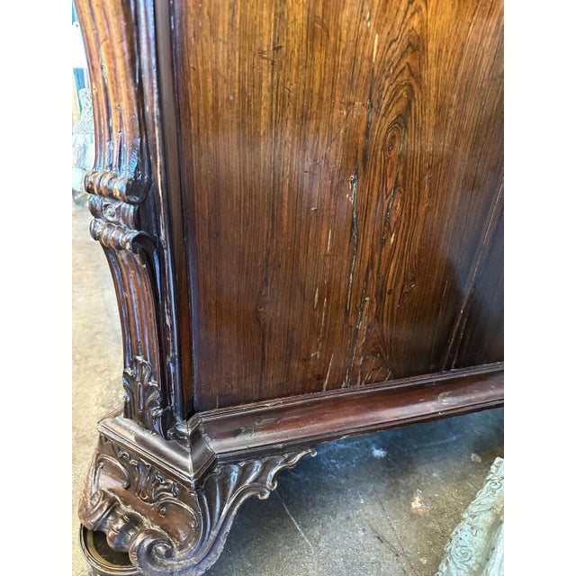 Rare, hand-carved Padouk wood commode from Portugal. A clipped corner top surmounts richly carved, cascading side-...