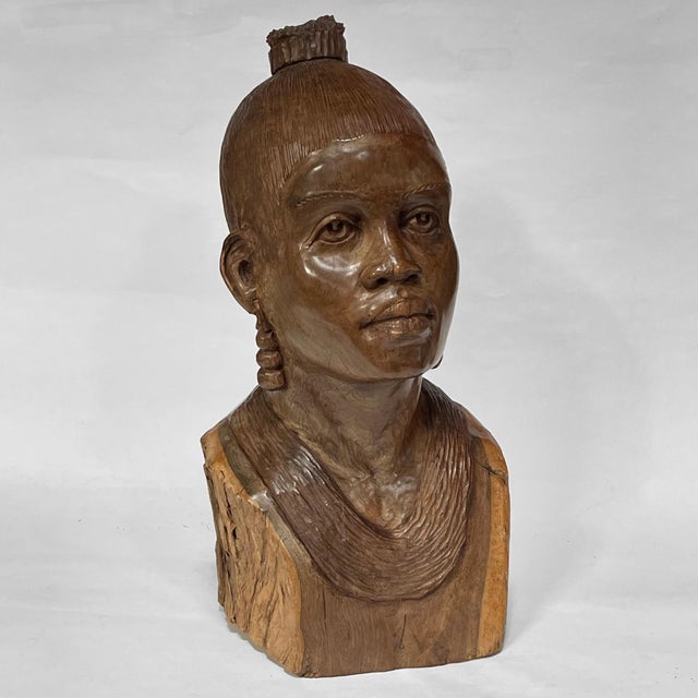 This exquisite bust by African artist Abraham Chikumbirike is carved from dense ironwood. The finely detailed likeness of...