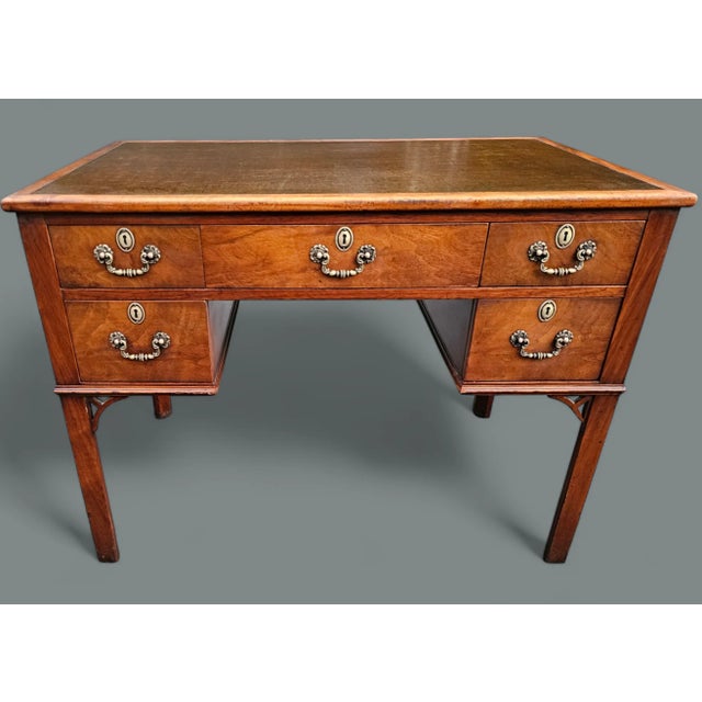 This Antique Chippendale Style Mahogany Leather Top Desk is a classic example of Chippendale furniture design, with...
