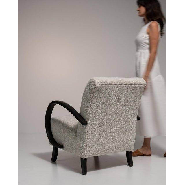 This chair carries genuine presence, its cream/oatmeal boucle upholstery immediately setting the tone for the piece. It...