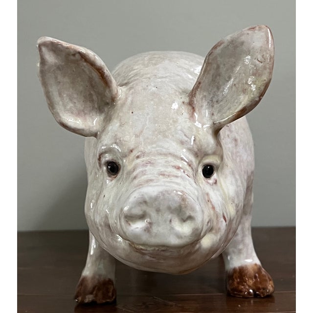 Hand made terra cotta pig or sow with a tin glaze and glass eyes.