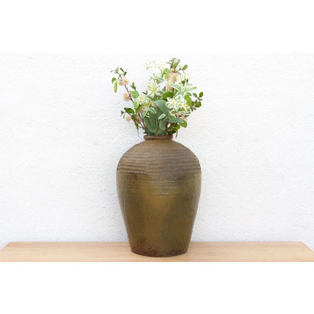 This large stoneware jug is a testament to the elegant practicality of traditional design and craftsmanship. Likely...