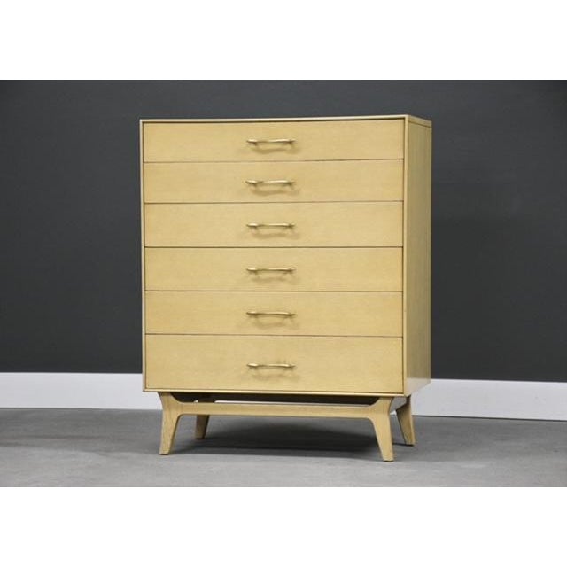 A mid century modern oak tall dresser with canted legs and brass drawer pulls made by RWAY Furniture. Original finish is...