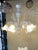 Classical venetianTransparent and milky-white Murano glass chandelier with flowers and leaves. Traditional piece of...