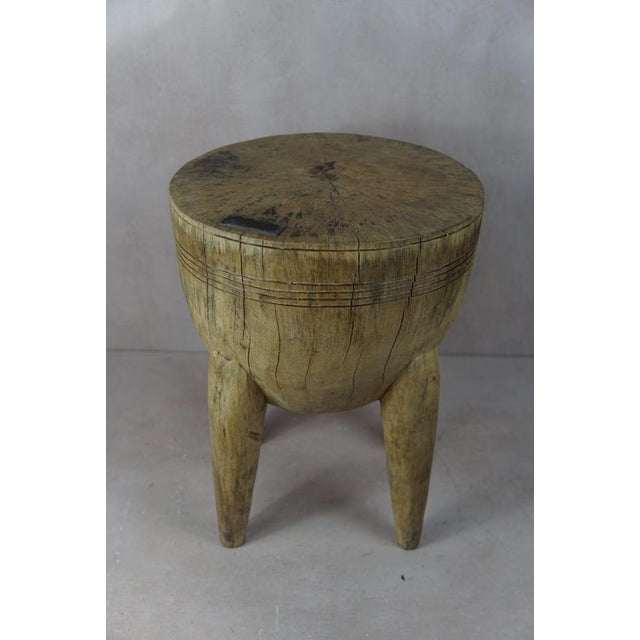 Introduce a touch of African elegance into your living space with this remarkable solid wood carved side tablestool from...