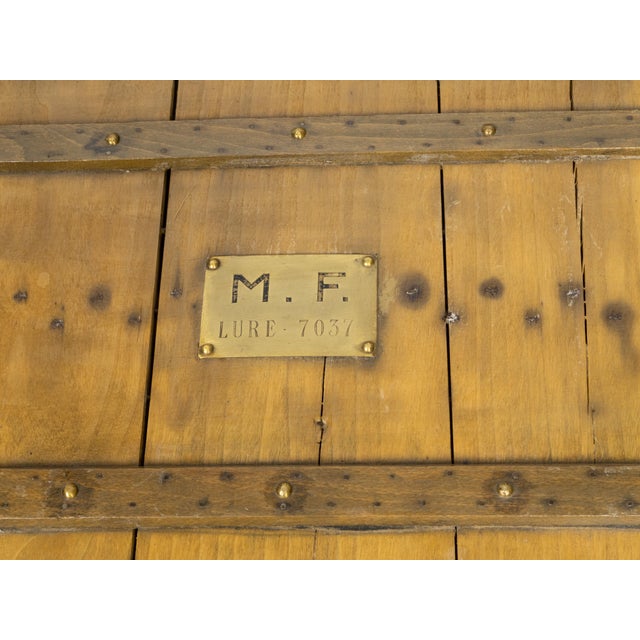 A French Lavolaille pine trunk from the early 20th century, with brass accents and monogram. Created in France during the...