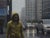 Yellow Raincoat Study by Joevic Yeban | Oil Painting of a figure in a yellow raincoat in the city. For Sale