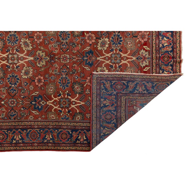 This exquisite Vintage Mahal rug showcases the timeless artistry of Persian weaving. Featuring a vibrant terracotta field,...