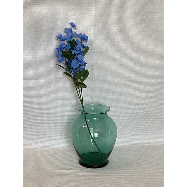 A mid-century modern Bottle Green Blown Glass Vase is a vintage piece from the Mid 20th Century. Single family owned since...