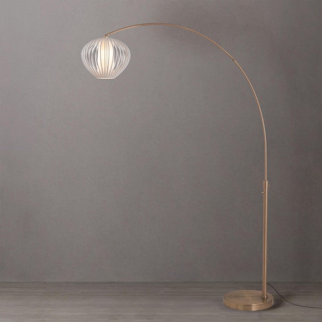 Weathered brass paired with a steel base defines the Float Arc Lamp, an elegant arc lamp designed to illuminate spaces...