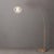 Weathered brass paired with a steel base defines the Float Arc Lamp, an elegant arc lamp designed to illuminate spaces...