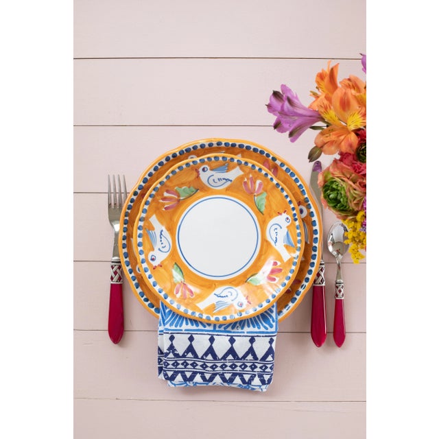 The colorful orange and blue Campagna Uccello Oval Platter features whimsical handpainted birds and flowers. Mix with...