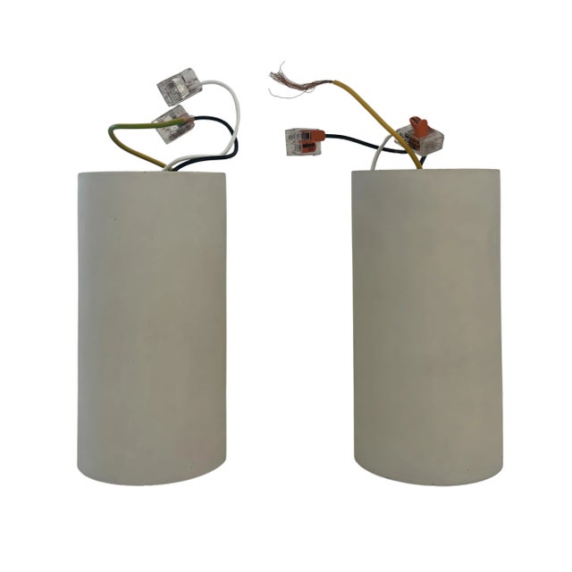 A pair of two concrete or plaster flush mount canned or tubed lights, custom made. These give a low downlight and are not...