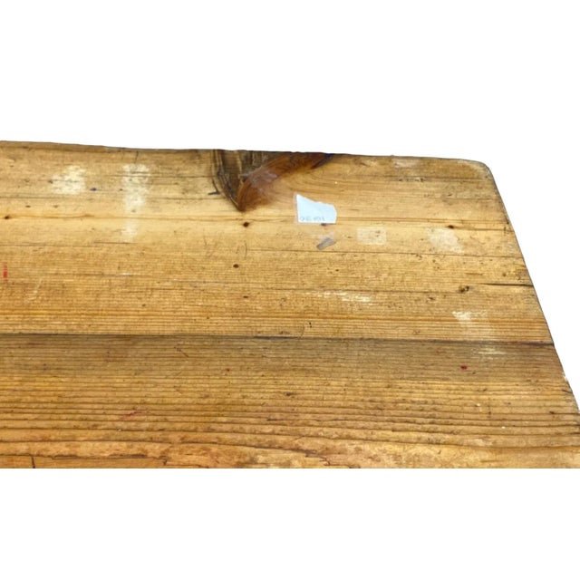 This exquisite piece from the early 20th century - a very large oak rustic farm table that is sure to make a lasting...