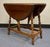 Elegant vintage splayed leg drop leaf side table with butterfly supports. Crafted in solid cherry with beautifully turned...