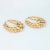 Fine detailed pair of oval hoop earrings crafted in 14k yellow gold. The stylish earrings feature an elaborate scrolled...
