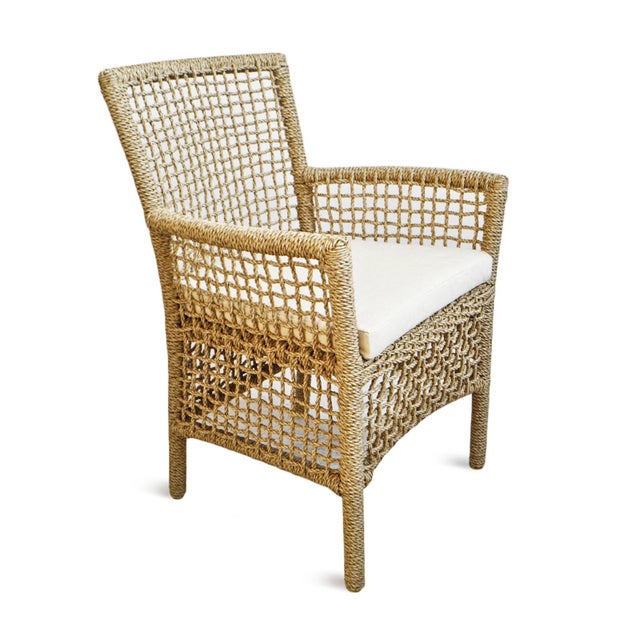 Outdoor woven synthetic hyacinth rope dining arm chair. Includes loose beige waterproof seat cushion. Each chair may vary...