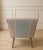 A stylish upholstered bench featuring softly sculpted, raised sides and a tufted seat in a warm woven fabric of muted...
