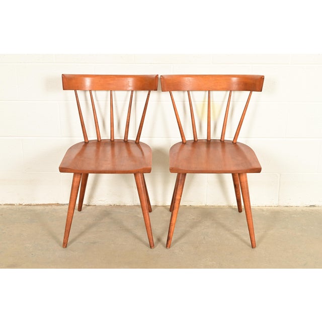An exceptional pair of iconic Mid-Century Modern solid birch spindle back side chairs or dining chairs By Paul McCobb for...