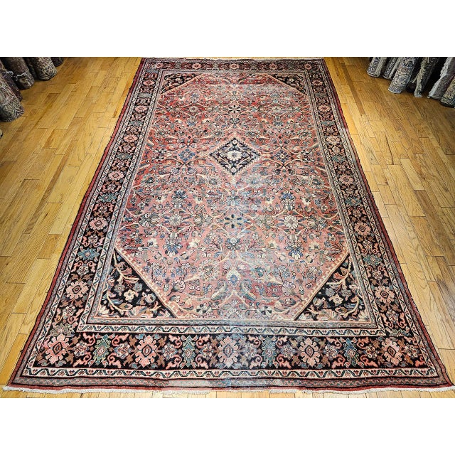 A beautiful example of early 20th century Persian craftsmanship, this vintage oversized Mahal-Sultanabad rug was handwoven...