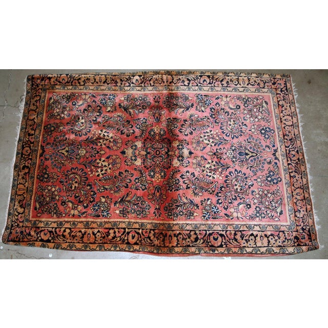 Handmade antique Persian Sarouk rug in original good condition. The rug is from the beginning of 20th century made in pink...