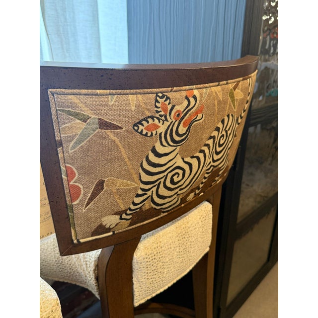 Elevate your space with our stylish barstools. Featuring cream fabric, and a stunning animal print that adds a bold...
