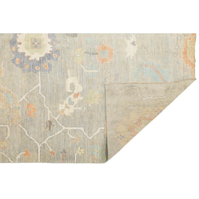 Elevate your space with the elegance of this Modern Oushak-style rug. Hand-knotted from premium wool, it features a low-...