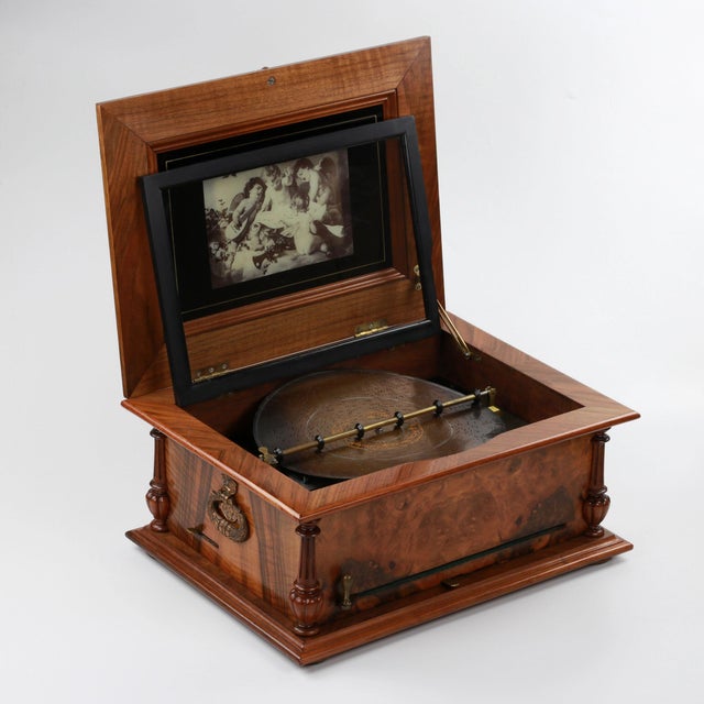 Polyphon music box 19th century, in a wooden case with singing birds marquetry in the frame panel, corner balusters and...