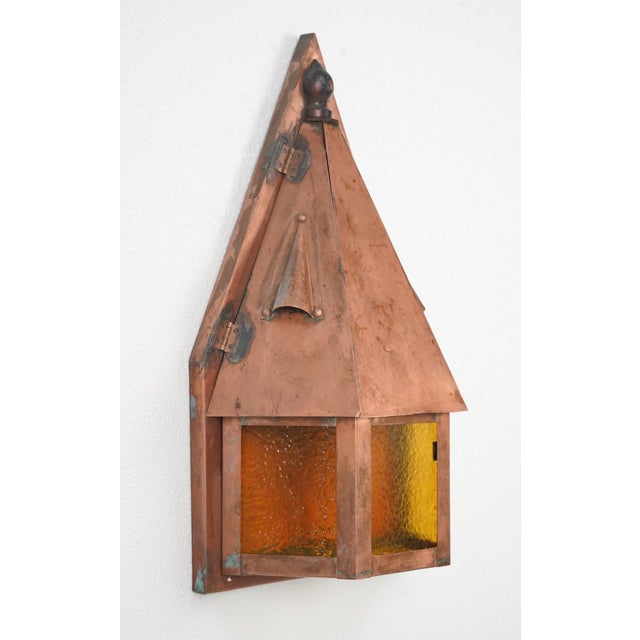 Arts & Crafts wall sconces made of polished copper with amber textured glass panels. Each sconce requires two Edison style...