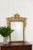 Antique French giltwood mirror with an ornately carved frame, shaped crest, and beveled glass. A classic statement piece...