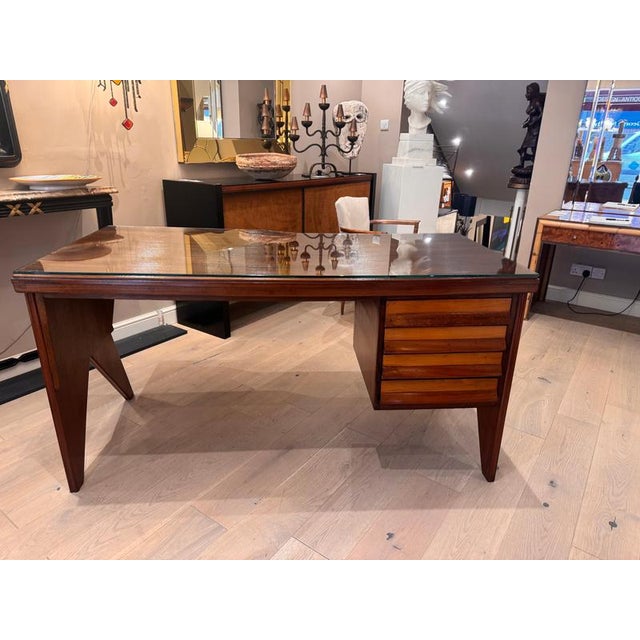 A beautifully crafted walnut and cherrywood writing desk with many interesting designs. Asymmetric reeded top with a heavy...