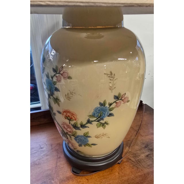 Vintage Oriental lamp. It is glass and I believe it may be reverse glass painting. The front of the lamp is full of...