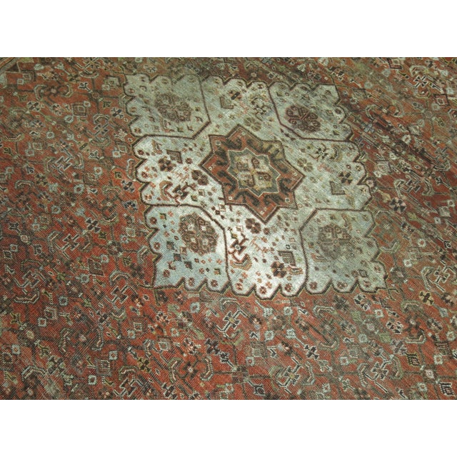 Early 20th century room size Persian rug with a tribal medallion motif on a brown rust ground. 8'8'' x 10'10''