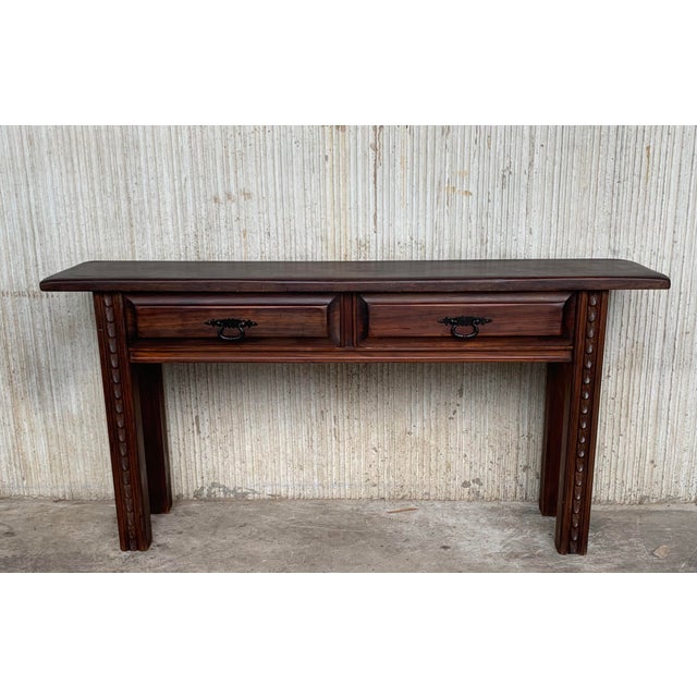 About An 19th century Spanish Baroque console, or writing table made of solid walnut with carved shaped legs. Two...