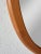The wide, rounded frame and warm teak wood give this large oval mirror an almost sculptural appearance. A fine piece of...