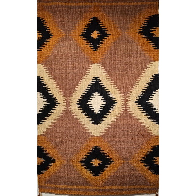 A striking example of Navajo textile artistry, this vintage Eye Dazzler rug originates from the Southwestern United States...