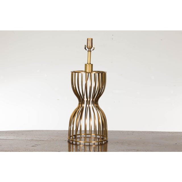A Midcentury Modern Italian Brass hourglass shaped table lamp with single socket and newly and professionally rewired for...