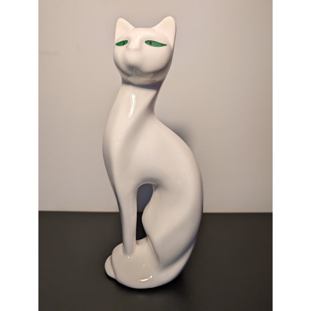 This elegant white mid century modern cat sculpture stands 12" tall and serves as an accent piece or can possibly take on...