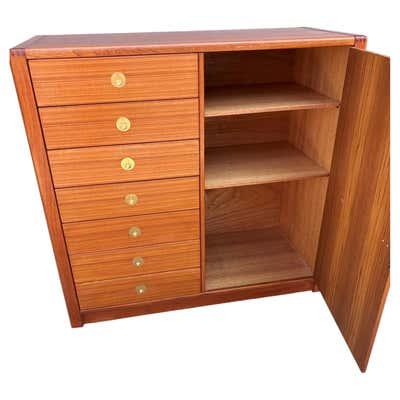 D-Scan Teak Cabinet/ Dresser. 7 Drawers with brass pulls on the left and one door that opens to reveal a ton of storage...