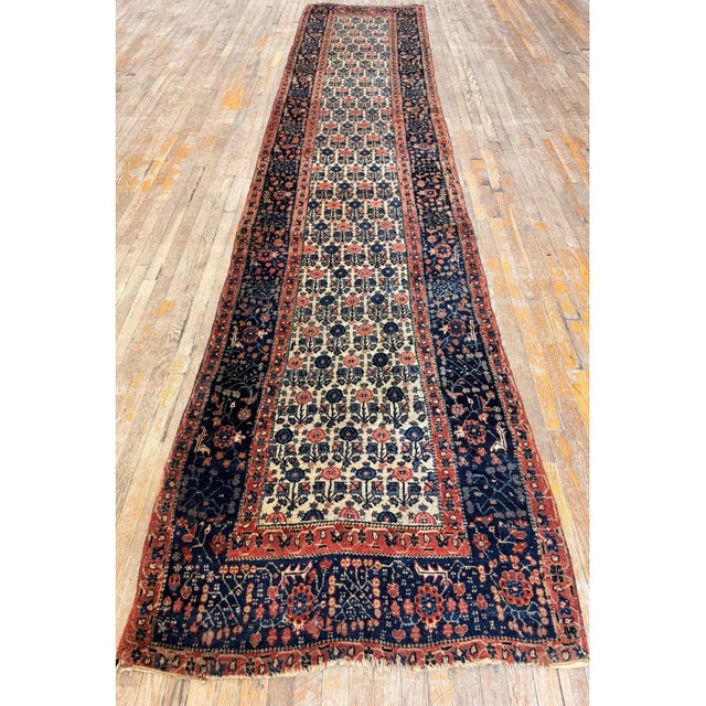 The Antique Persian Bijar Rug is characterized by its "Iron Rug" durability, featuring a dense, hand-knotted, wet-woven...